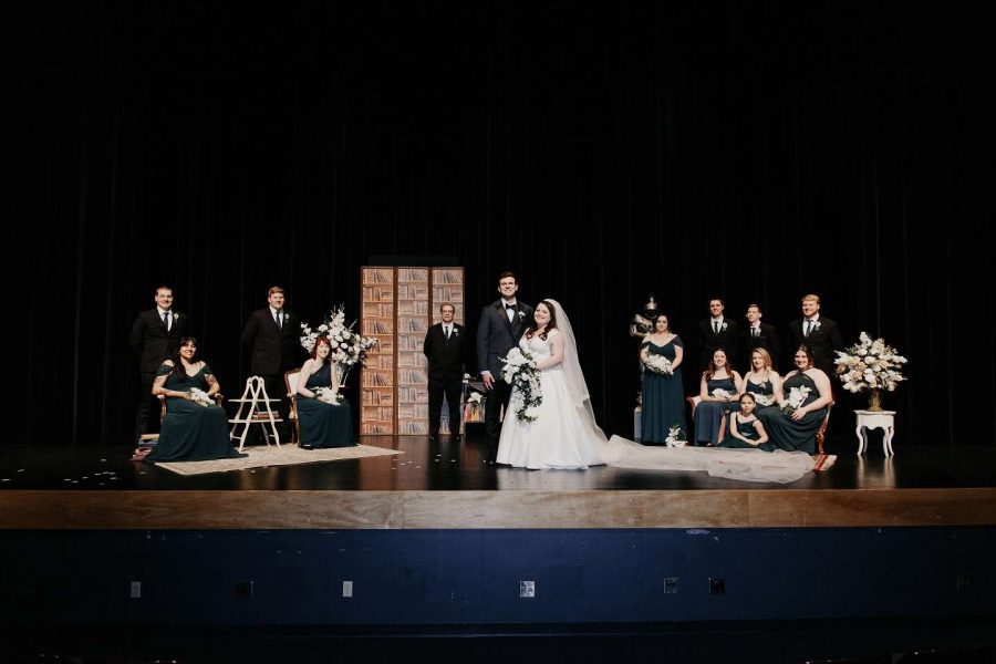 Wedding party photos on top of the stage at Schauer ARts Center in hartford, wisconsin.