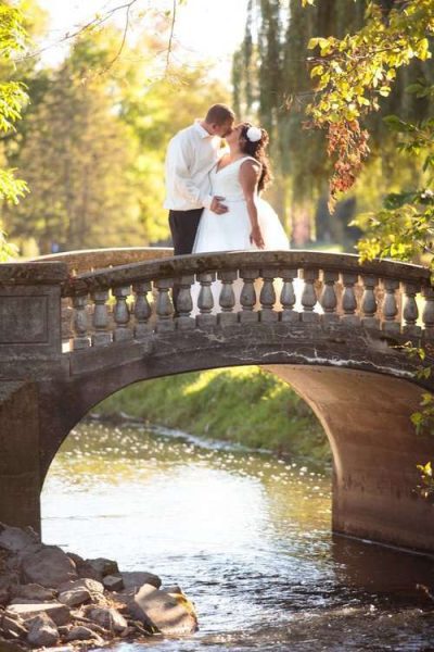 Bride and groom kiss in bridge at Watertown Country Club