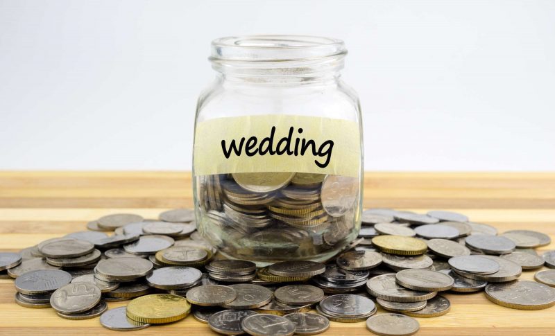 wedding budget planning mason jar on coins