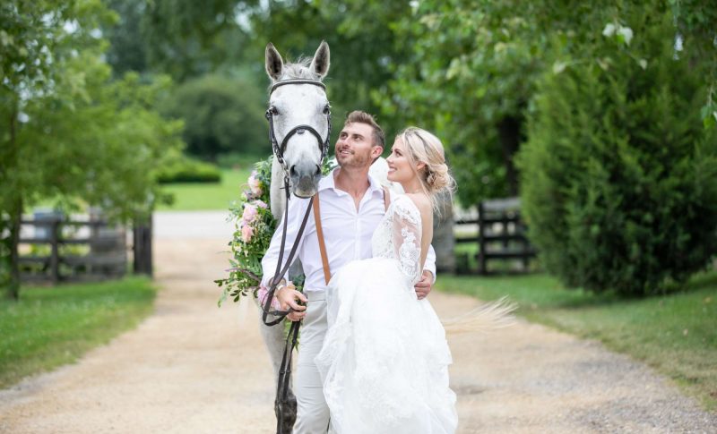 Bride and groom with white horse