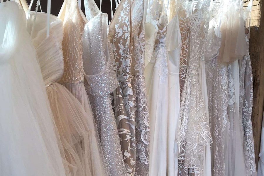 Beautiful selection of wedding gowns hanging on a rack