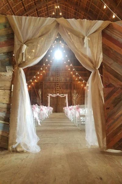 Barn Wedding Ceremony at the Hay Loft with beautiful white drapping