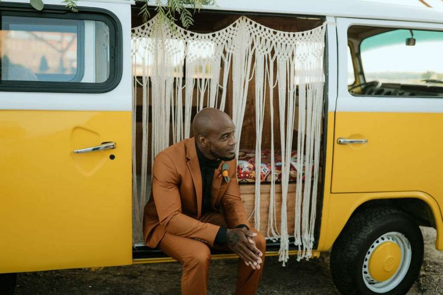 Stylish groom sits in the Yellowbus Photo Booth.
