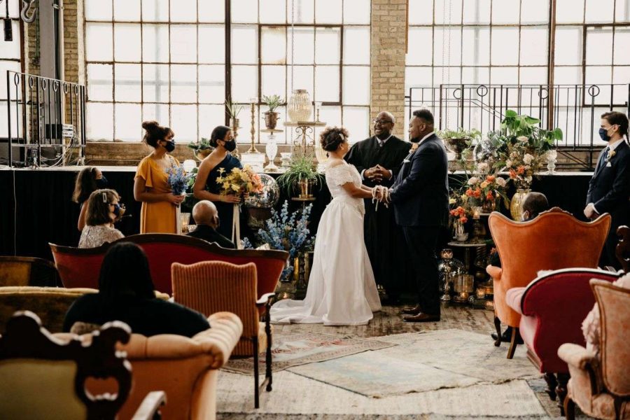 Bride and groom say their I do's at the a beautiful boho ceremony at the Cooperage, Milwaukee, WI