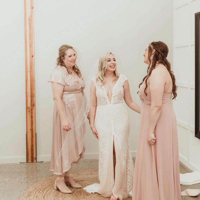 Kaitlyn and two bridesmaids share a moment before the ceremony