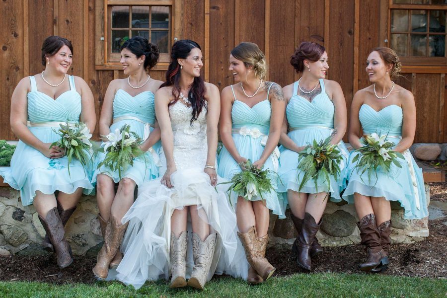 Bride and bridesmaids wear cowboy boots.