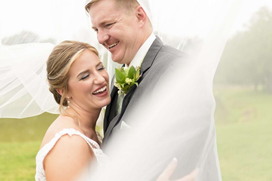 Bride and groom laugh as they pose fro wedding portraits-Allysha Noelle Photography
