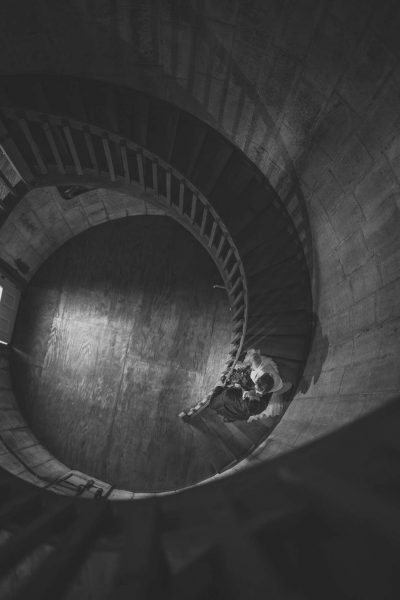 Bride comes down wide winding staircase-Allysha Noelle Photography