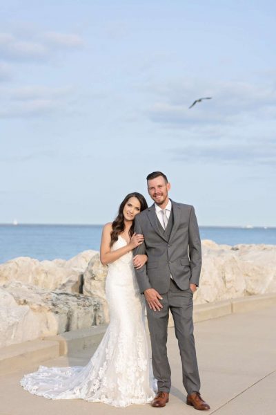 Bride and groom pose by Lake Michigan-Allysha Noelle Photography