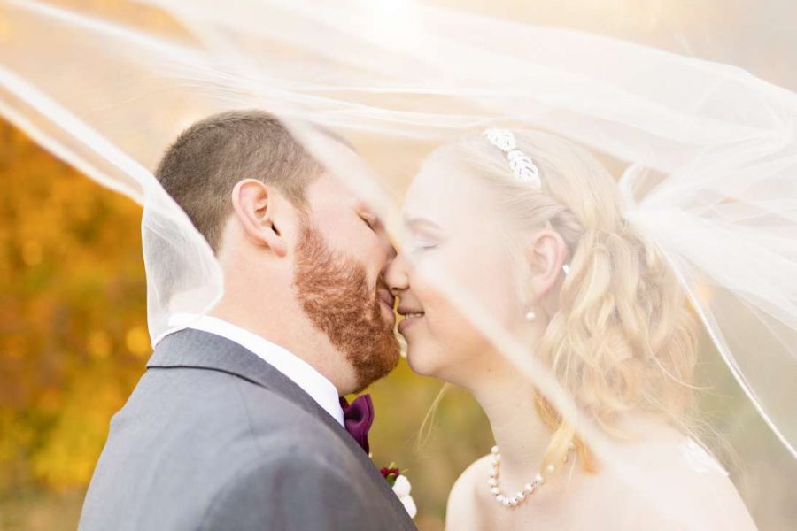 Bride and groom kiss under her veil-Allysha Noelle Photography