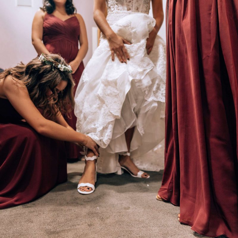 Bridesmaids help bride get ready