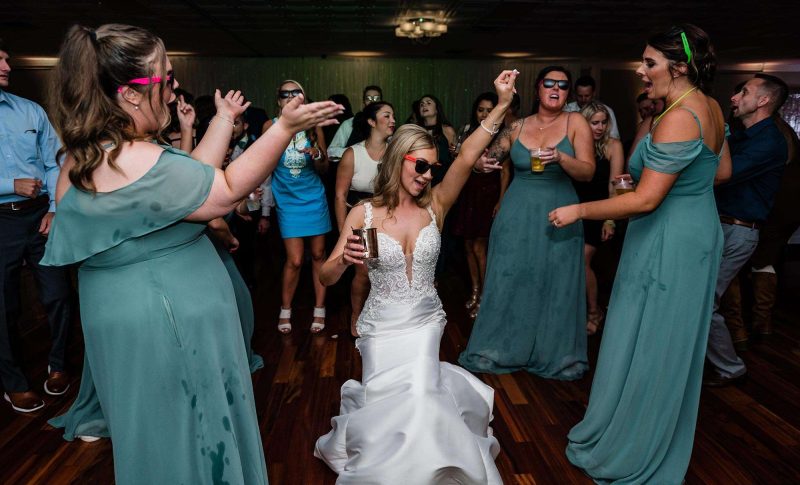 bride and some guests wearing sunglasses while dancing